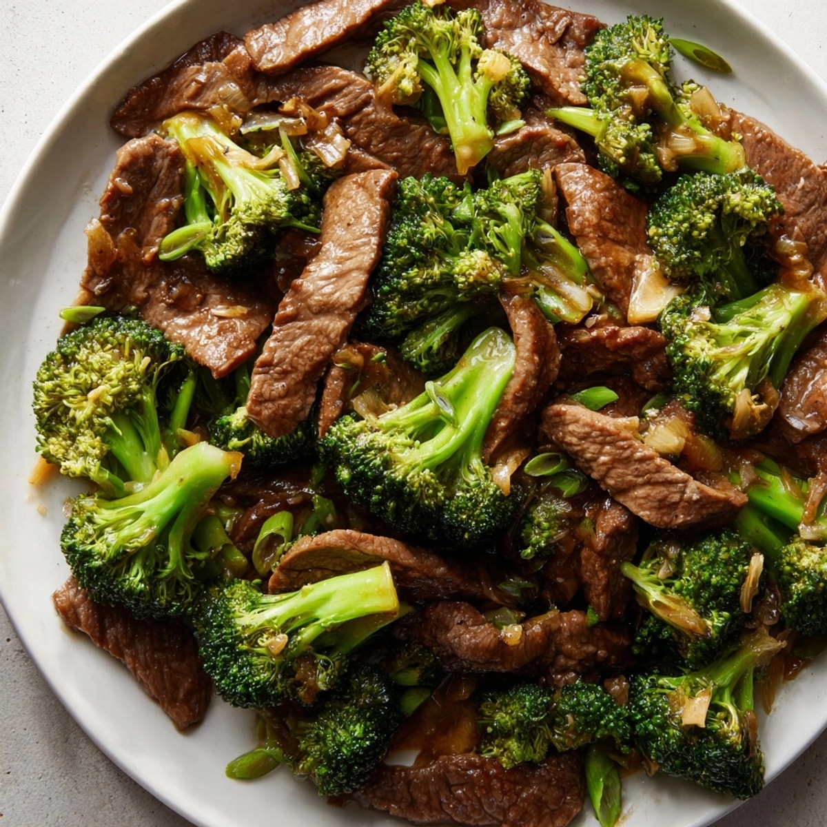 Close-up of Beef and Broccoli Stir-Fry: Perfectly seared beef glistens atop bright green broccoli.