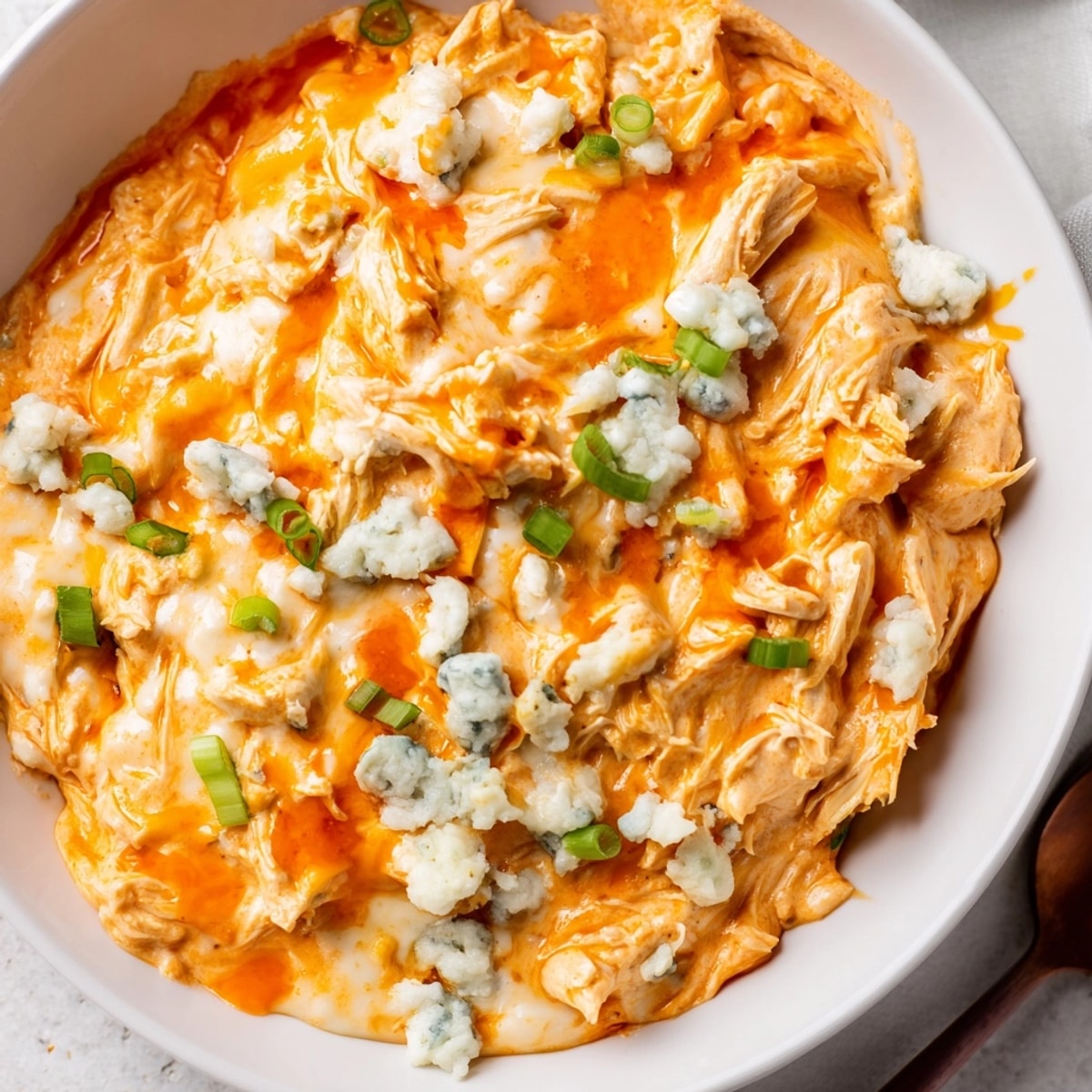 Creamy Buffalo Chicken Dip bubbling hot from the oven, ready for tortilla chips.