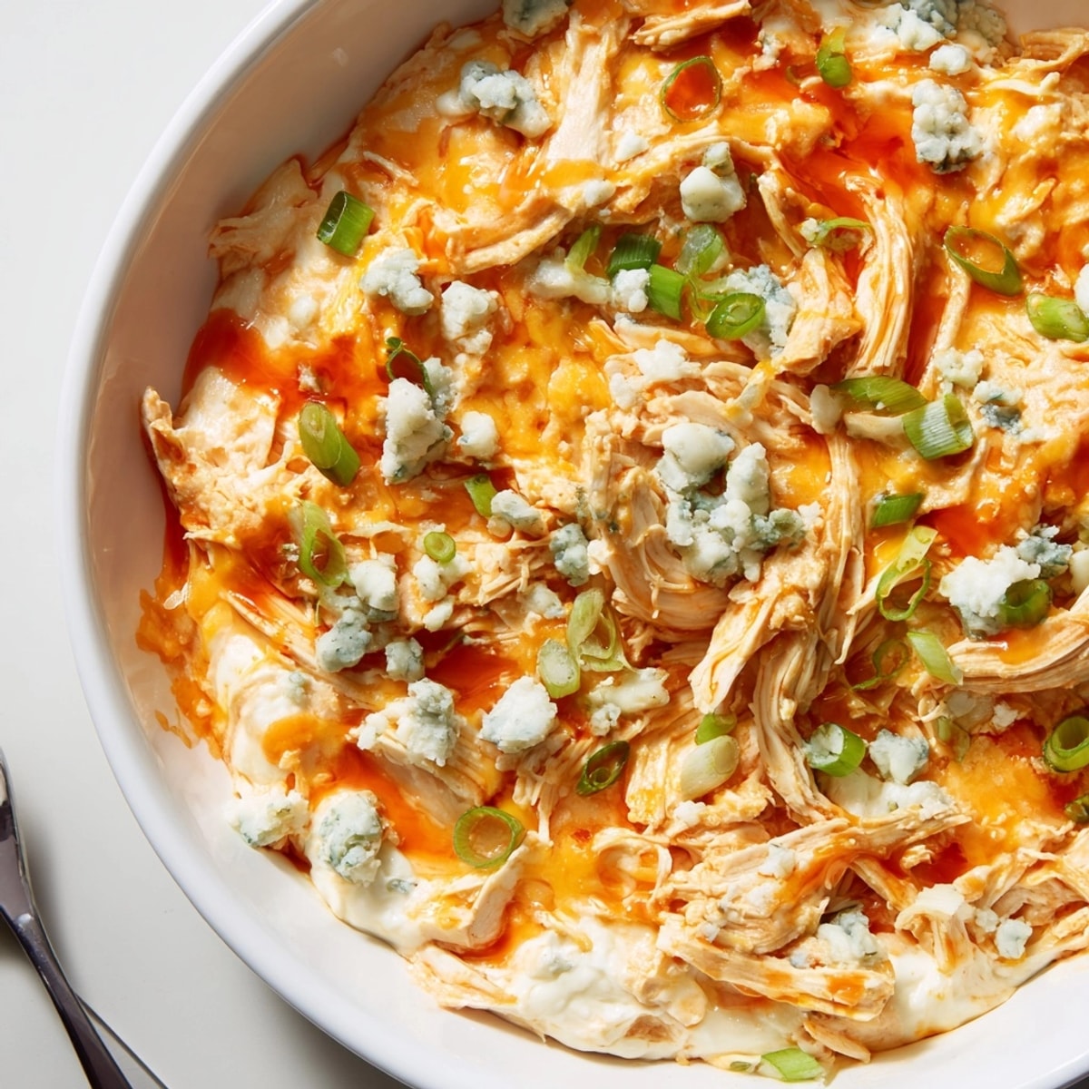 Baked Buffalo Chicken Dip: a spicy appetizer with melted cheese and shredded chicken.