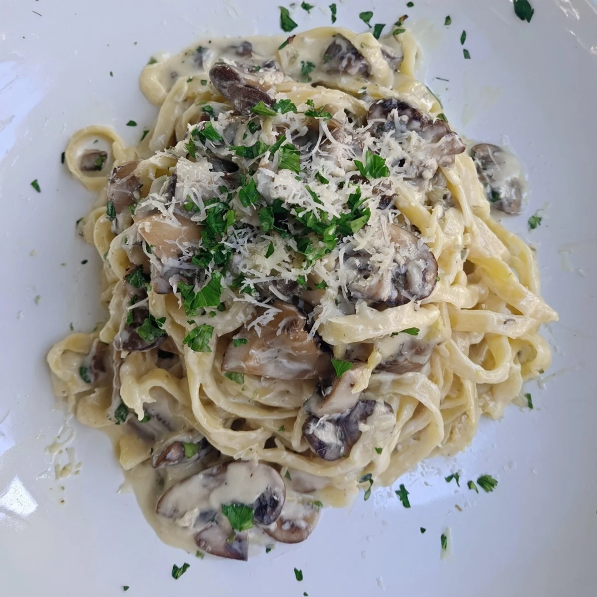 Spoonful of Creamy Goodness pasta with Parmesan garnish, perfectly plated, promising a delicious, savory Italian experience.