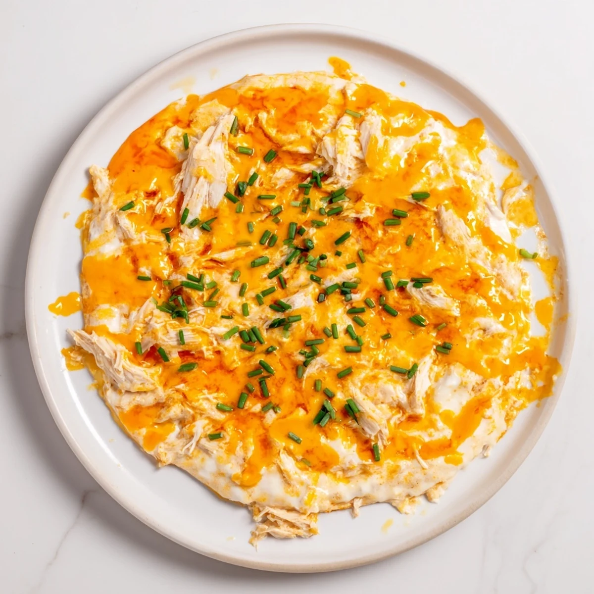 Steaming Spicy Buffalo Chicken Dip, bubbling hot with melted cheese and tender chicken, ideal for sharing.