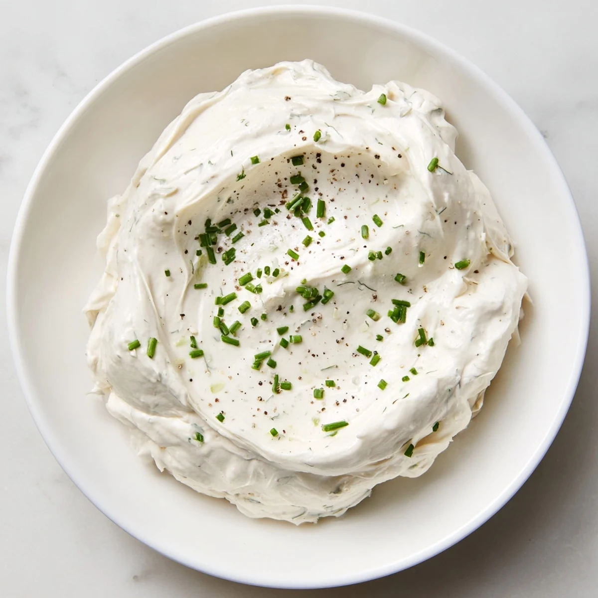 A creamy dip base, perfectly smooth, invites dipping with crisp veggies and crackers.