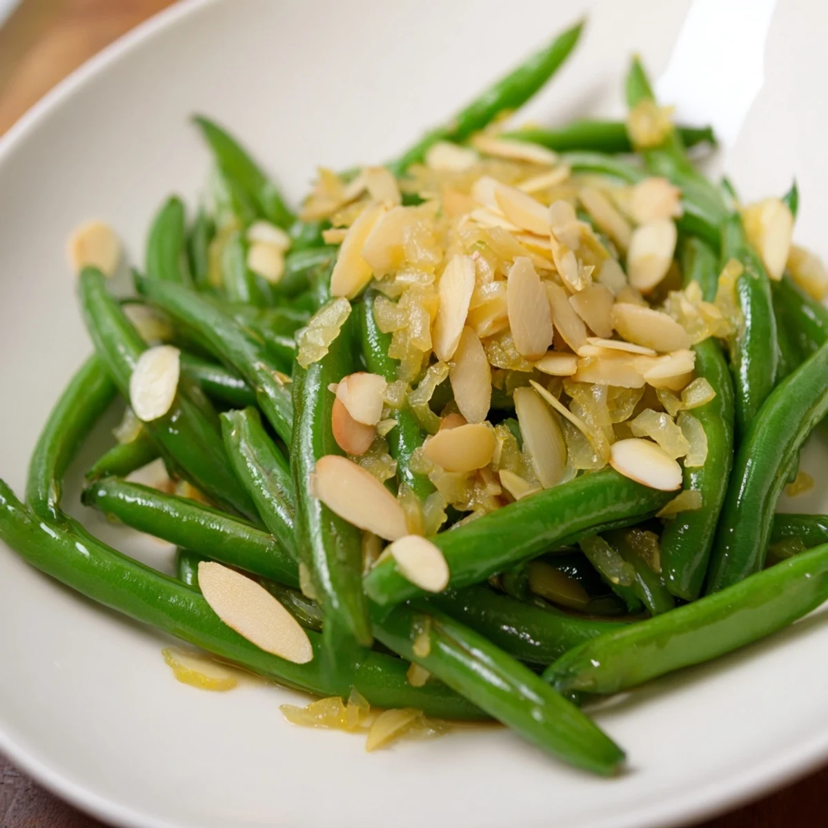 Steaming hot Green Beans Almondine, a vibrant side of tender green beans and toasted almonds.