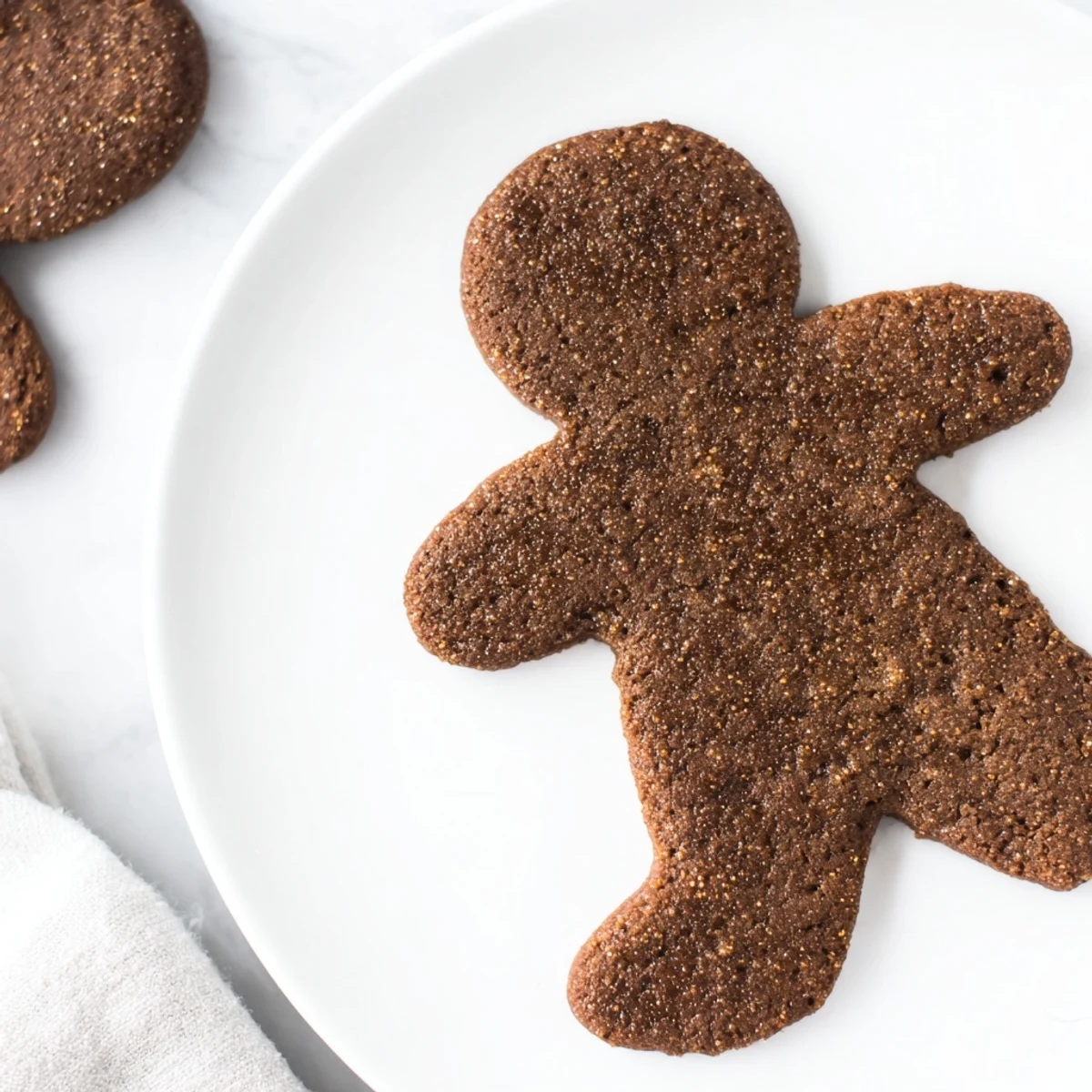 Golden brown gingerbread dough on a floured surface, prepared for cookie cutting and baking.