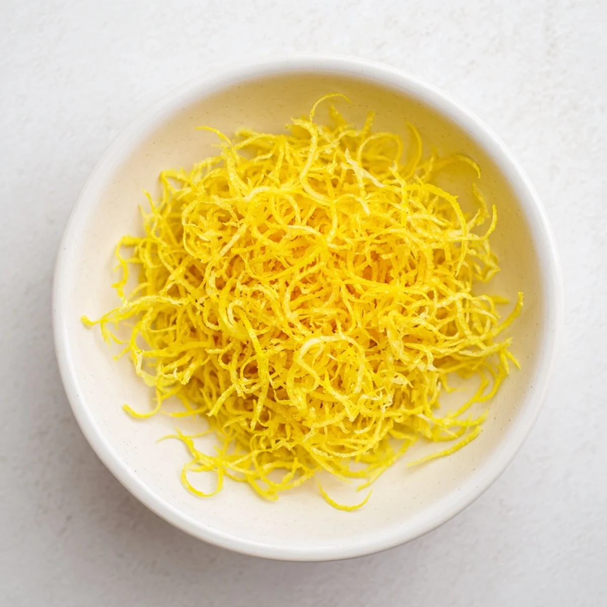 Finely grated lemon zest glistening, ready to add a burst of citrus to your favorite dishes.