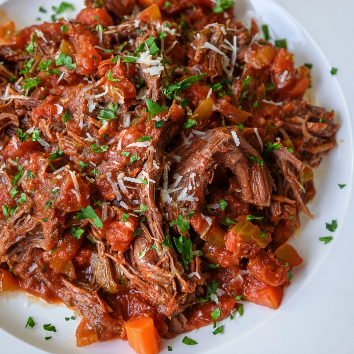 This slow cooked beef ragu, deeply flavored, overflows, inviting you to spoon it over pasta.