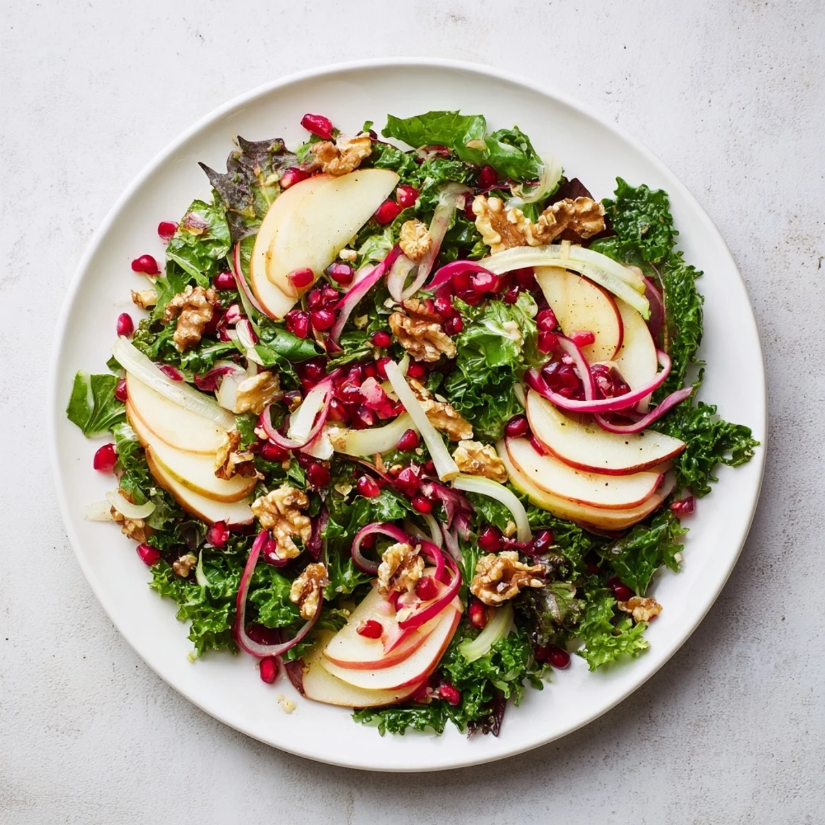 Fresh winter salad with pomegranate seeds, offering a colorful, flavorful holiday meal.