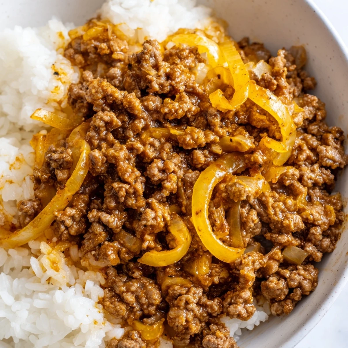 Topped with fresh thyme, this Beef Mince with Onions is served over creamy mashed potatoes.