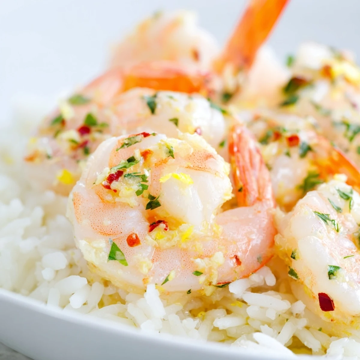 Sautéed Lemon Garlic Shrimp over Rice served with a glass of white wine.