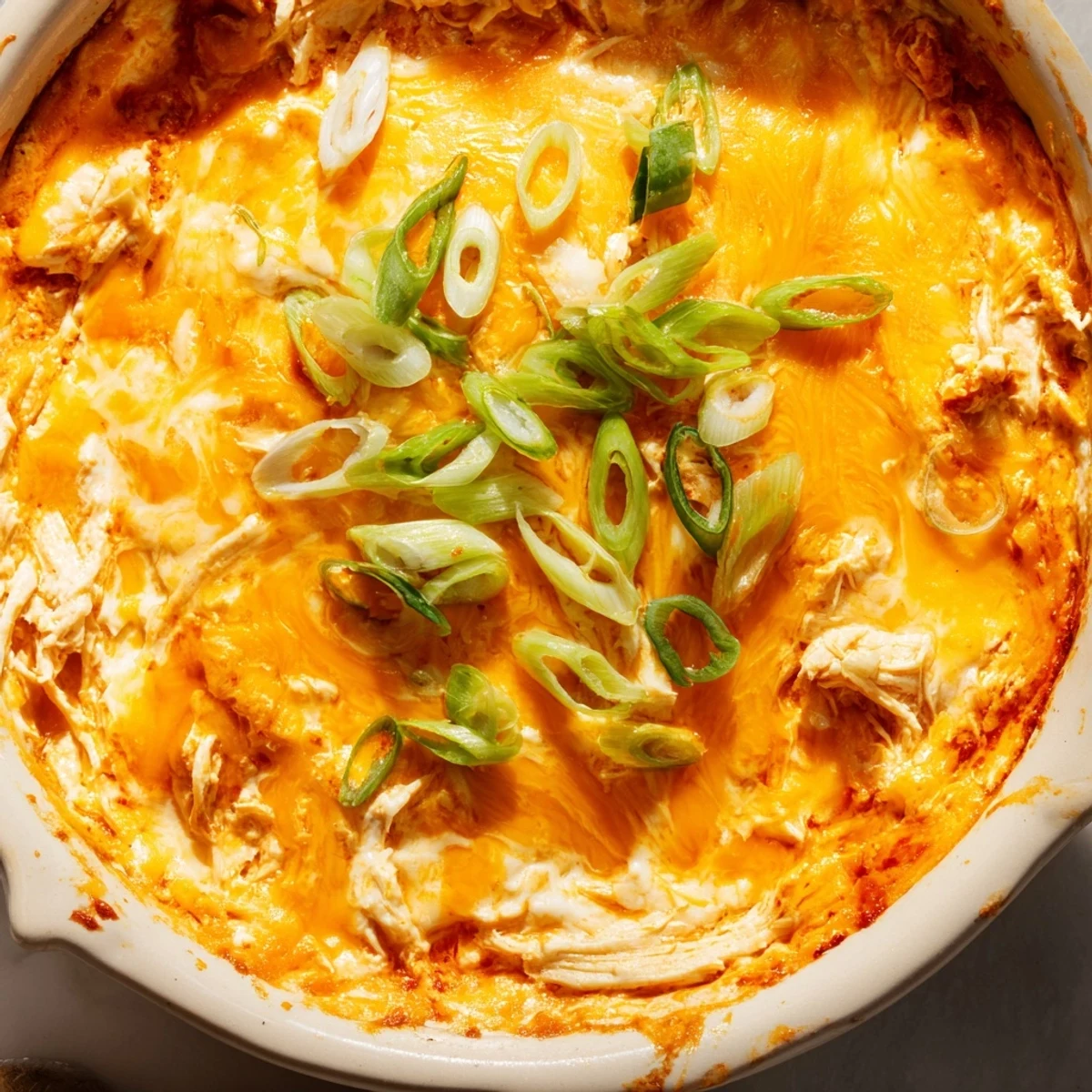Mouthwatering close-up of Spicy Buffalo Chicken Dip with melted cheese, perfect for a game day appetizer.