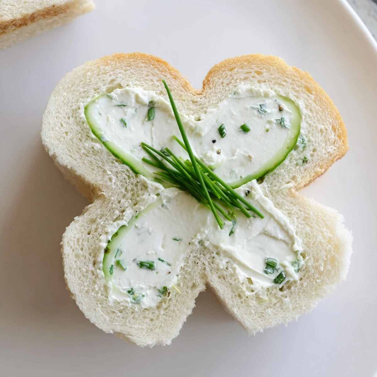 Soft white bread triangles cradling crisp cucumber slices and dill cream cheese filling, perfect for easy spring party appetizers.