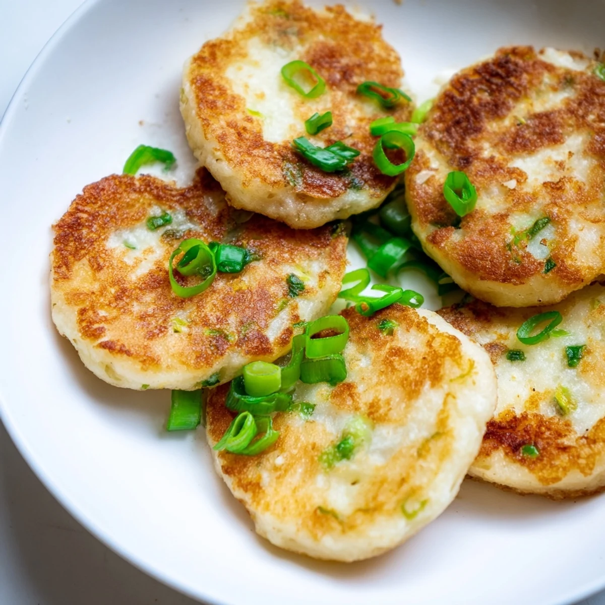 Hearty Irish Potato Cakes with Scallions on a breakfast plate, ready to be enjoyed alongside a hot cup of coffee or tea.