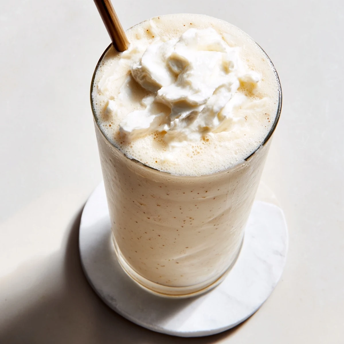 Homemade vanilla bean frappuccino blending ice and creamy scoops into a frosty, refreshing coffeehouse-style beverage.