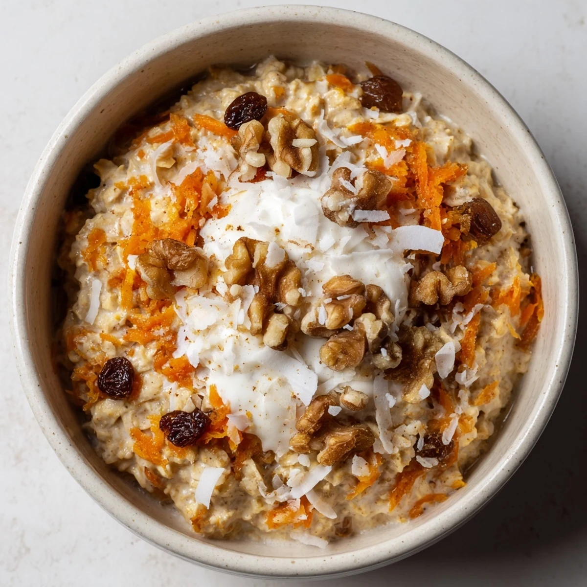 Creamy overnight oats topped with crunchy walnuts, shredded coconut, and a maple drizzle for a wholesome Carrot Cake Overnight Oats breakfast.