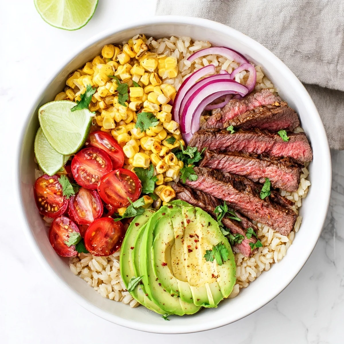 Steak Avocado Roasted Corn Bowl garnished with red onion, cherry tomatoes, and fresh cilantro.