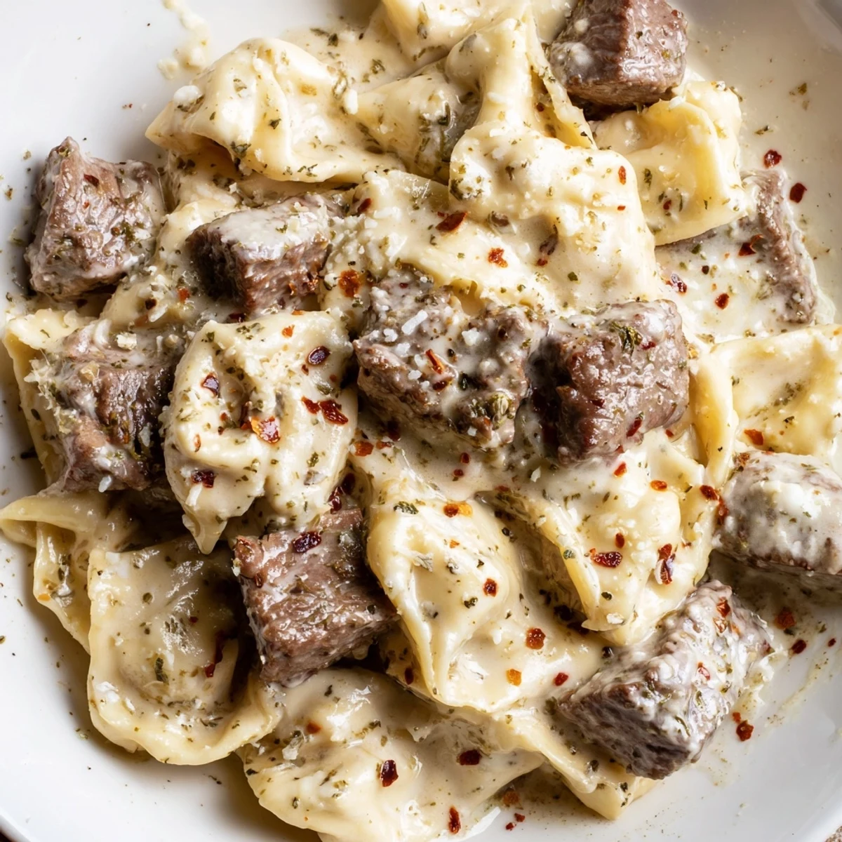 Creamy Garlic Steak Tortellini with tender sirloin cubes and cheesy pasta in a rich garlic parmesan sauce.