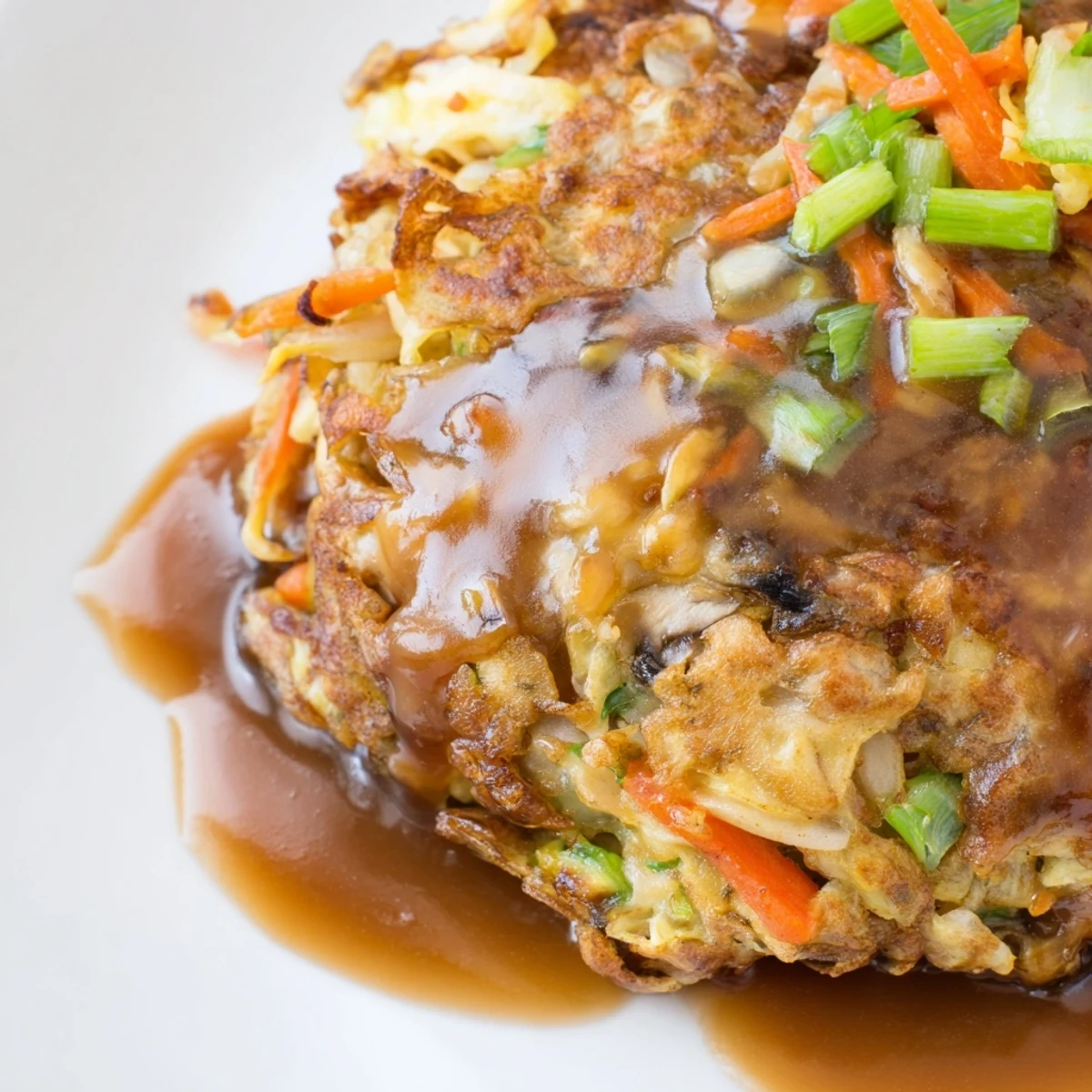 Homemade Egg Foo Young served hot with rich gravy and steamed white rice