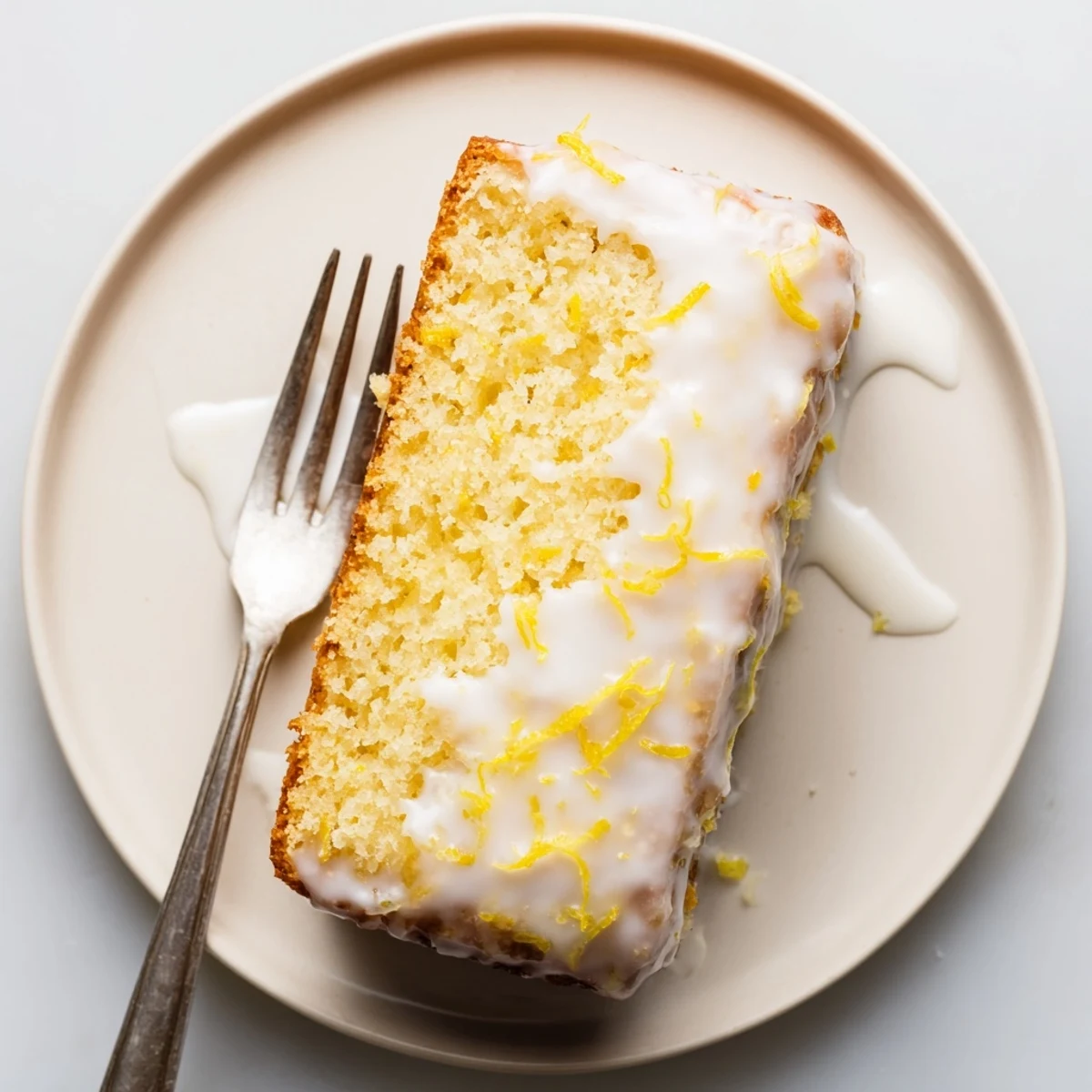 Delicious bright lemon loaf with glossy icing perfect for afternoon tea dessert