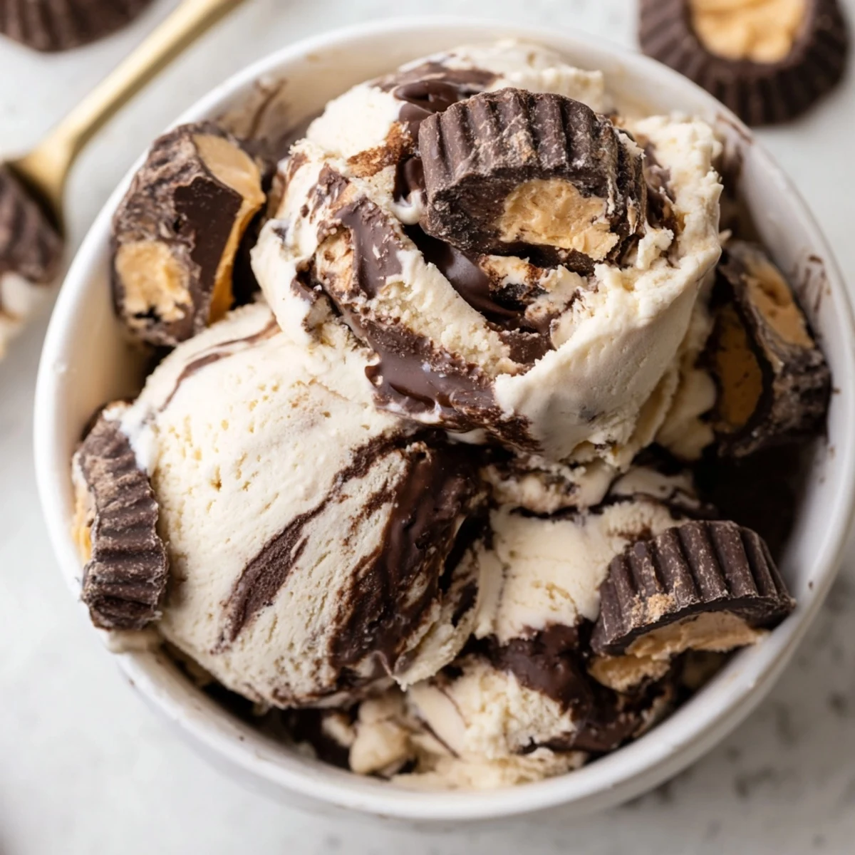 Creamy homemade moose tracks ice cream with fudge swirls and chocolate peanut butter cups