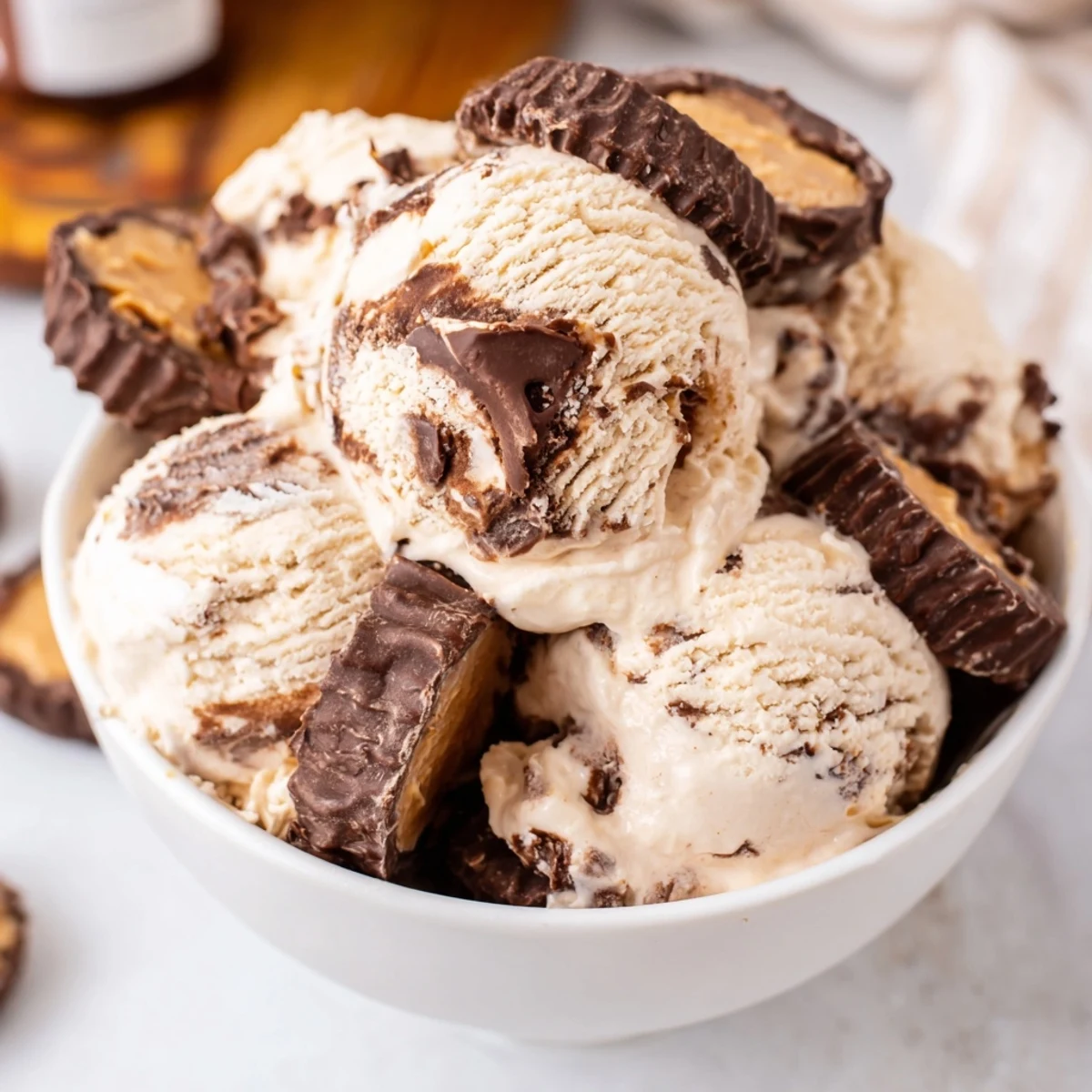 Rich homemade moose tracks ice cream featuring marbled chocolate fudge and peanut butter cup chunks