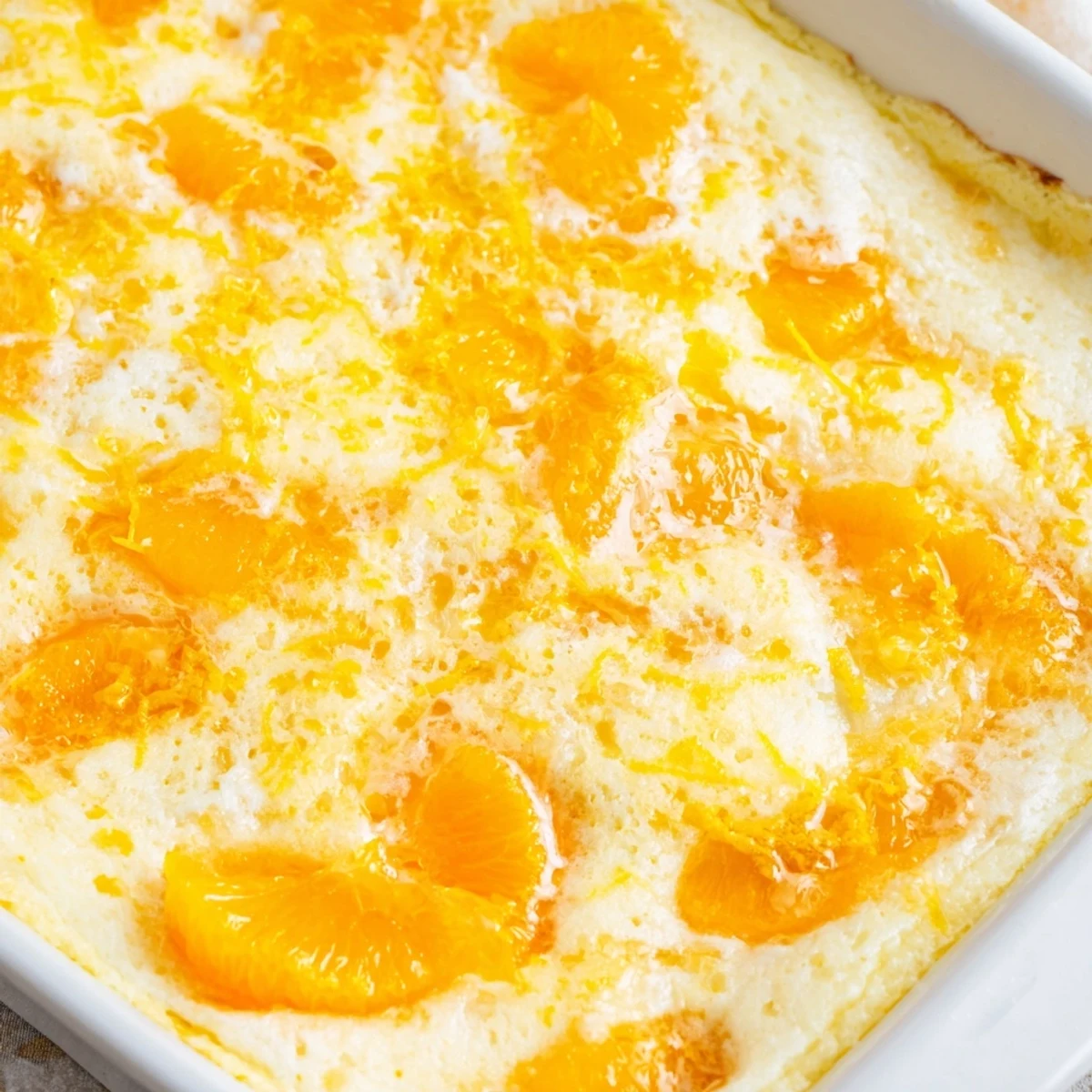 Zesty lemon dump cake fresh from oven featuring tender mandarin oranges and golden baked edges