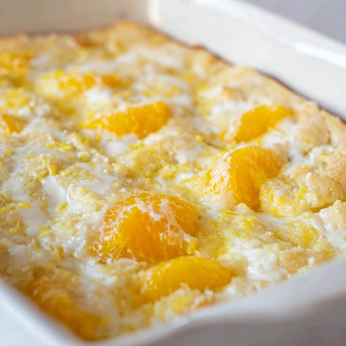 Warm citrus lemon dump cake slice showcasing tangy lemon filling and fluffy yellow cake layers