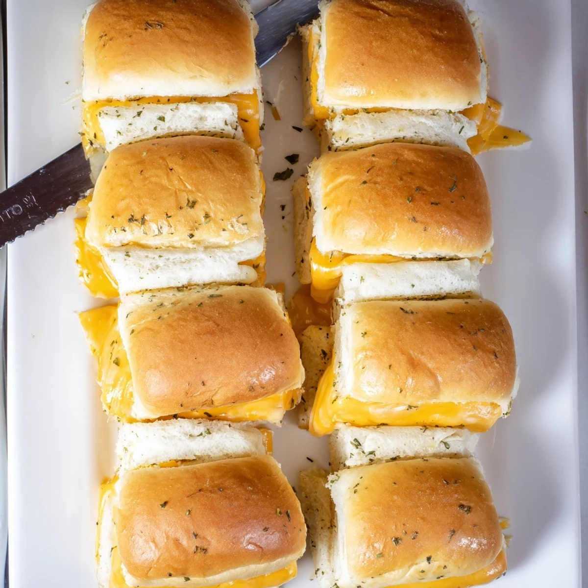 Soft sweet Hawaiian roll sliders stuffed with gooey cheese fresh from the oven
