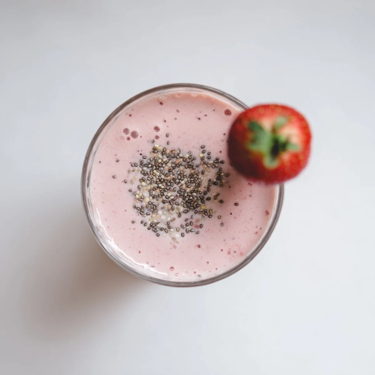 Creamy strawberry and Greek yogurt breakfast smoothie in tall glasses with straws
