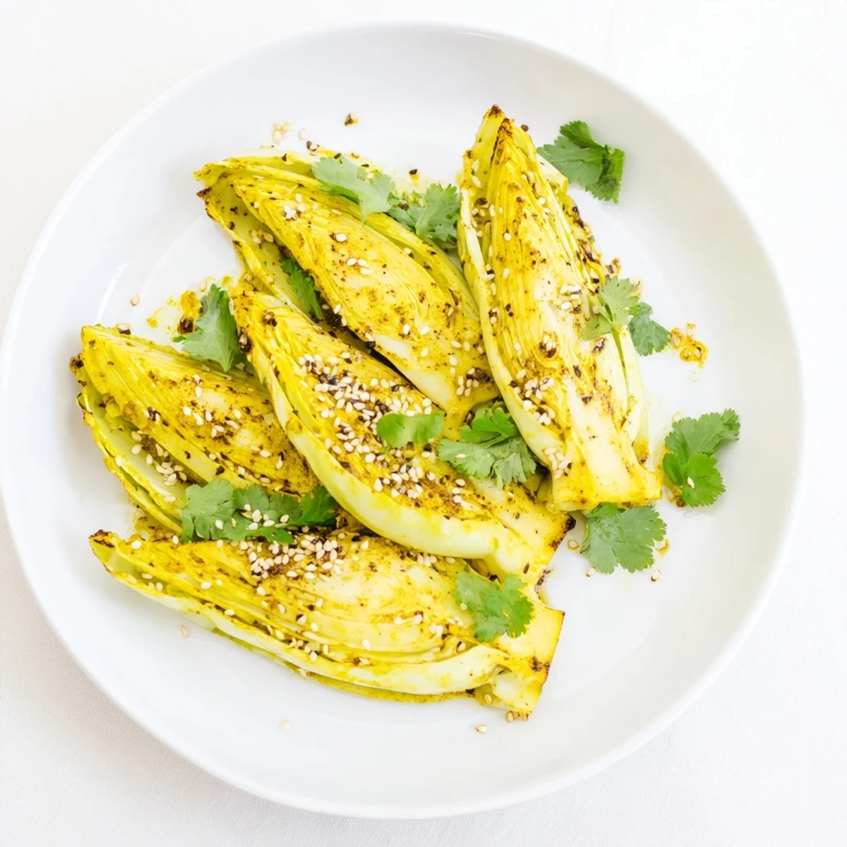 Close-up of spiced roasted cabbage showing crispy golden-brown edges and vibrant yellow curry coating