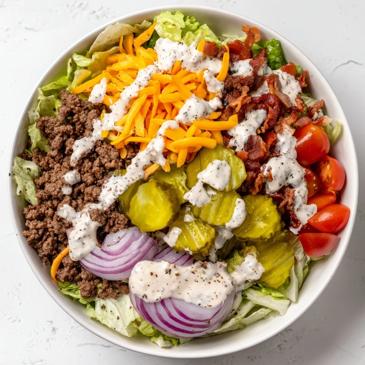 Burger bowls with seasoned ground beef, crisp lettuce, cheddar cheese, and special sauce drizzled generously on top