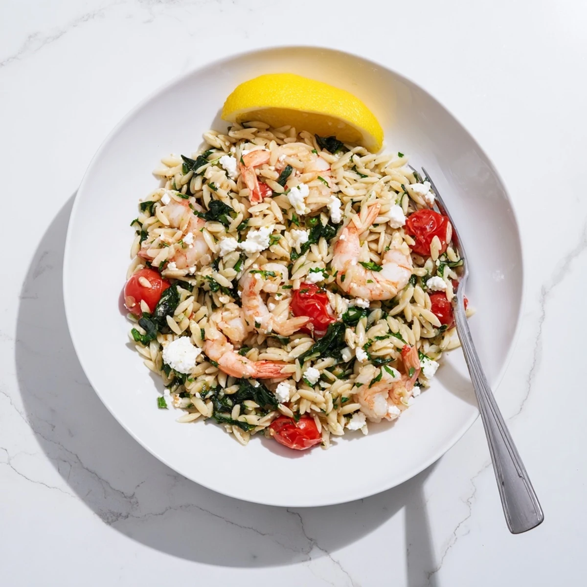 Creamy Lemon Feta Orzo Shrimp plated with fresh parsley and bright lemon zest garnish