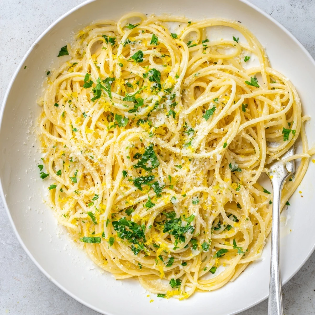 Close up of al dente one pot garlic butter pasta glistening with melted butter and parmesan
