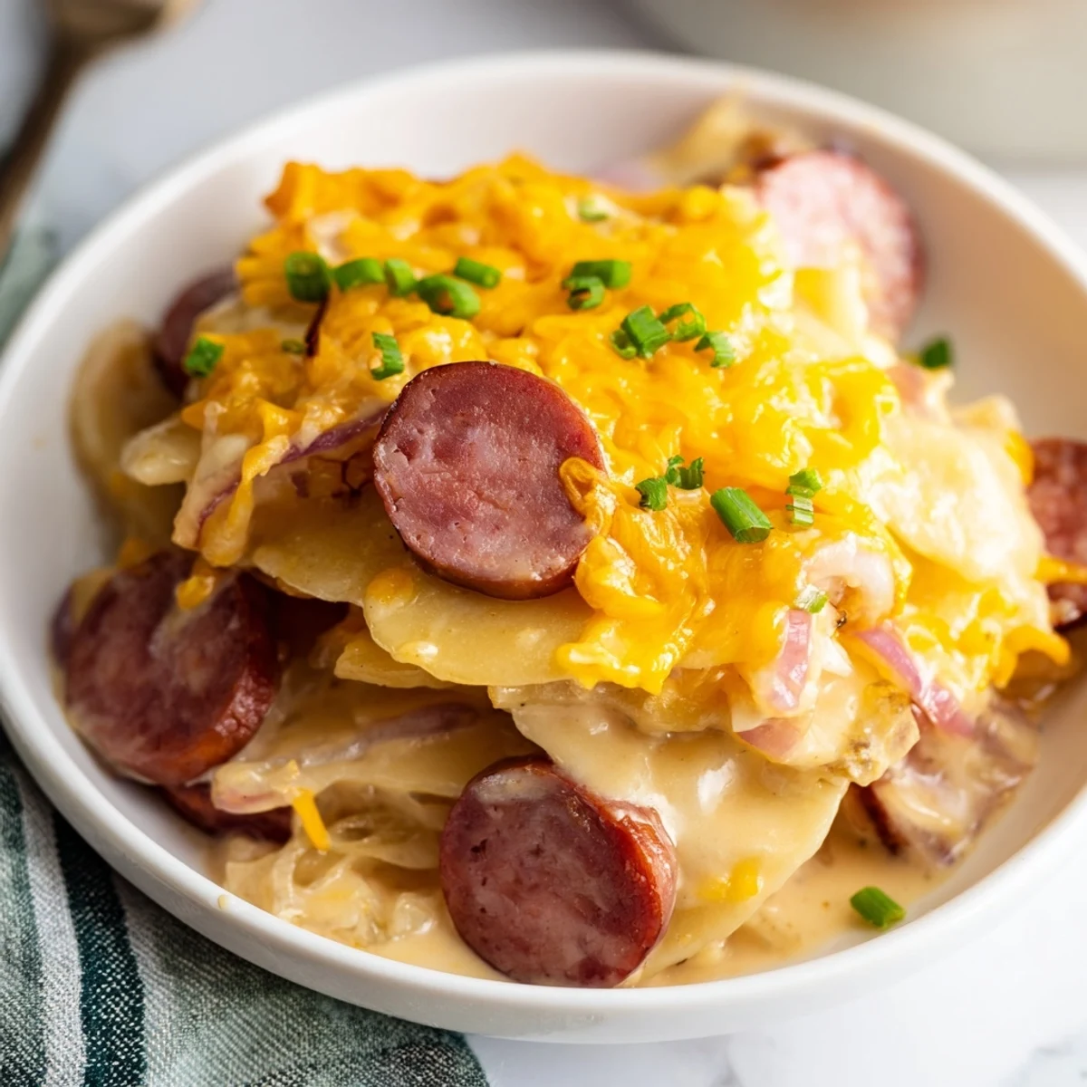 Golden melted cheddar covers pierogi and kielbasa in this slow cooker casserole