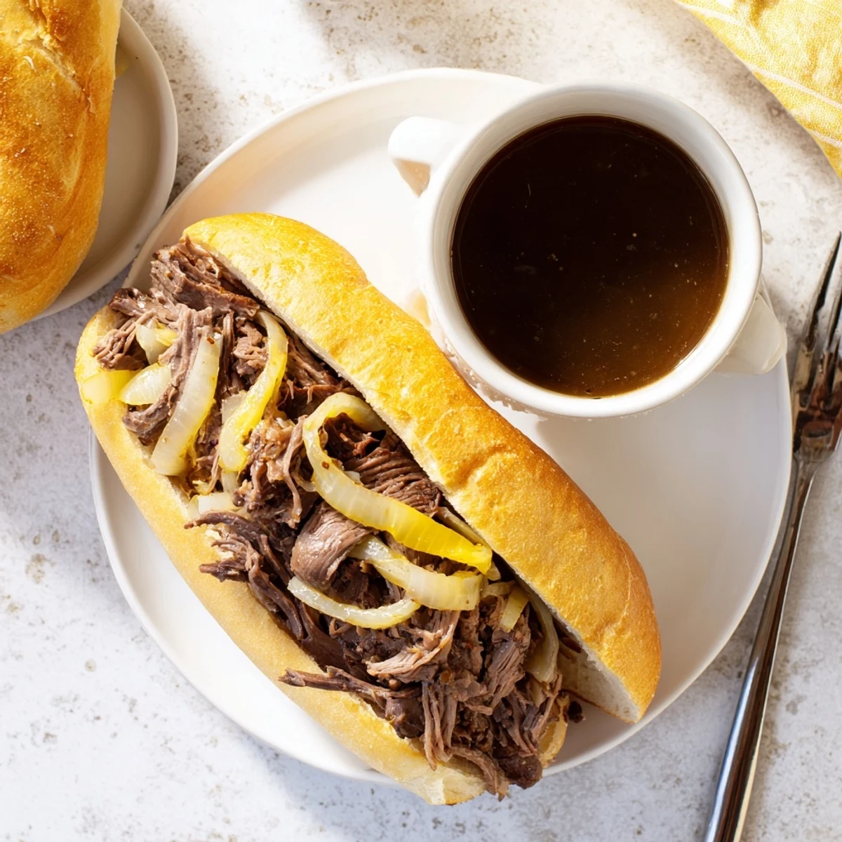Crockpot French dip sandwiches with juicy beef and melted cheese on fresh rolls perfect for dipping into warm au jus