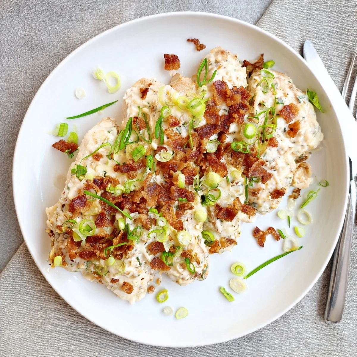 Tender Million Dollar Chicken slow cooked to perfection with rich cheese and crispy bacon garnish