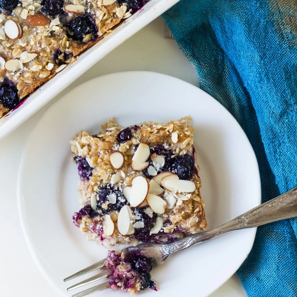 Warm blueberry cottage cheese breakfast bake served with maple syrup and fresh fruit