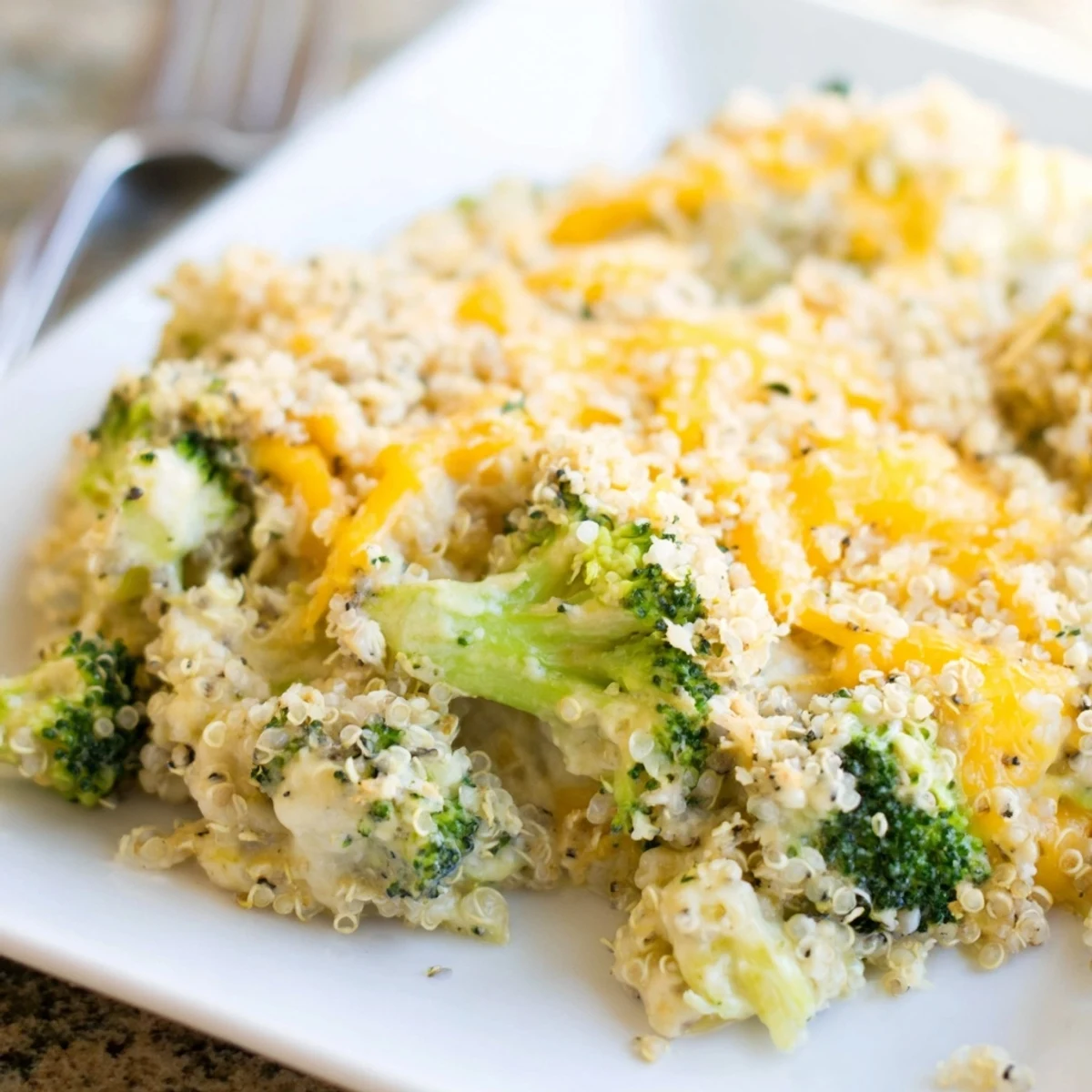 Tender broccoli and fluffy quinoa in a bubbling creamy sauce, topped with cheese