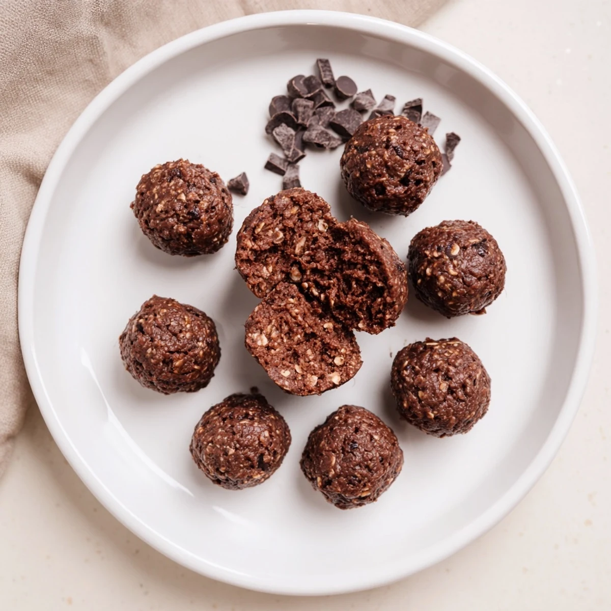 Brownie Protein Bites on a parchment-lined tray, rich and fudgy.