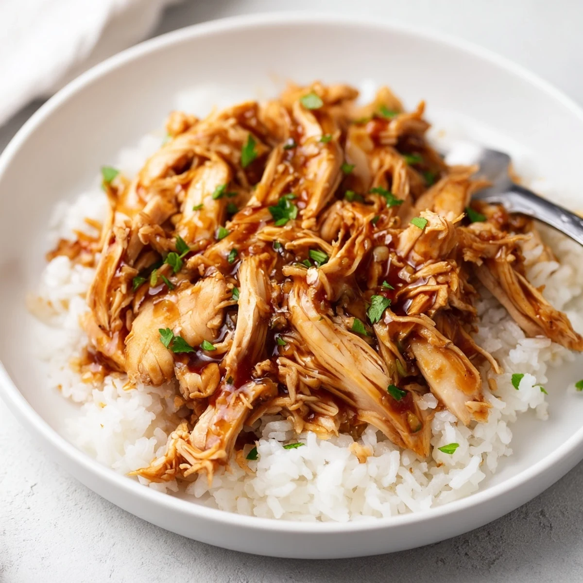 Slow-cooked Crockpot Honey Garlic Chicken, tender breasts bathing in sweet garlic glaze