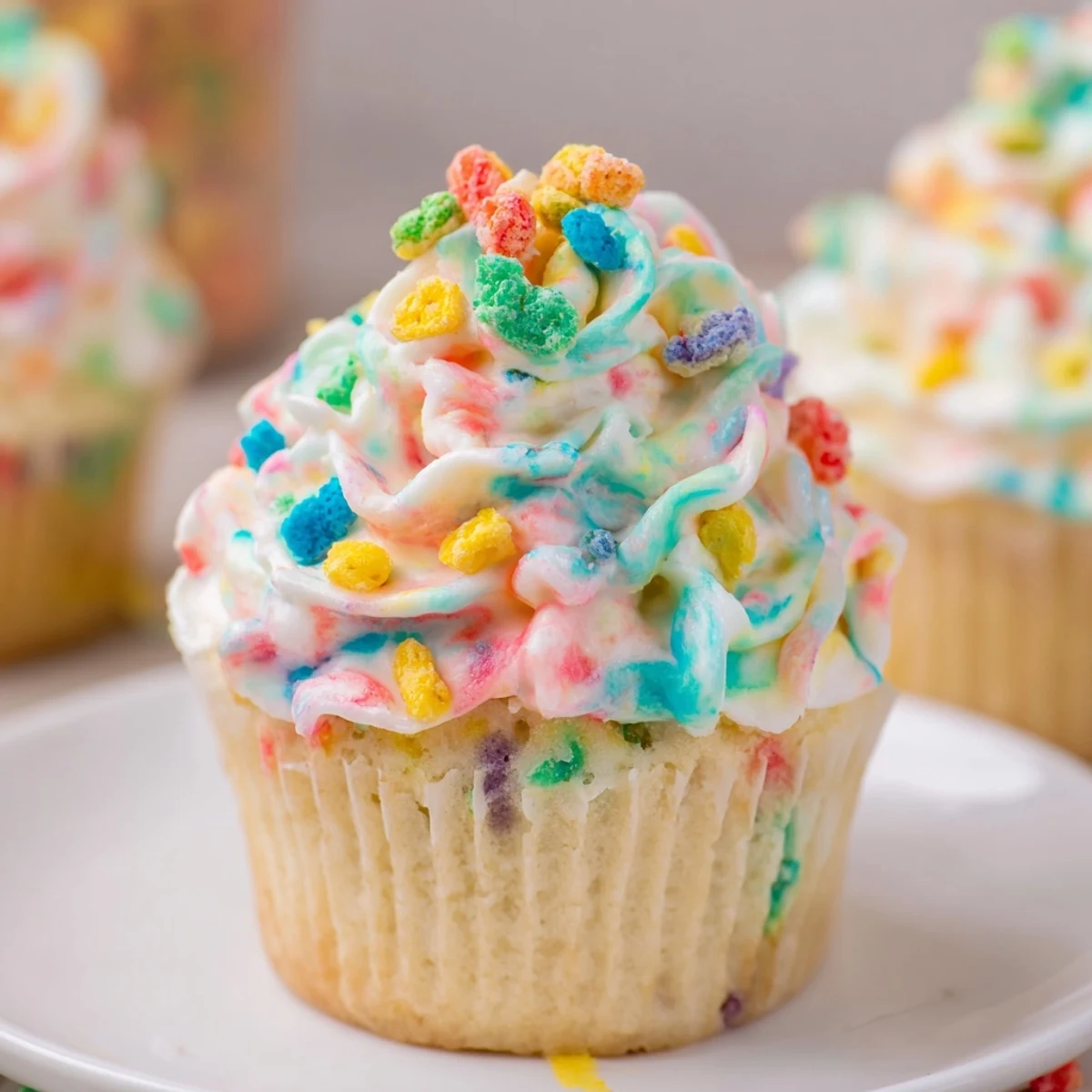 Scooped homemade Fruity Pebbles cereal frosting showing bright rainbow colors and creamy buttercream texture