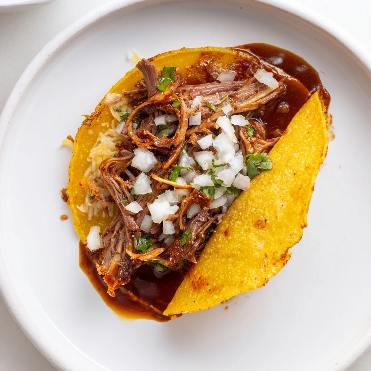 Crisp-edged Super Crispy Birria Tacos Recipe showing juicy shredded beef and melty cheese