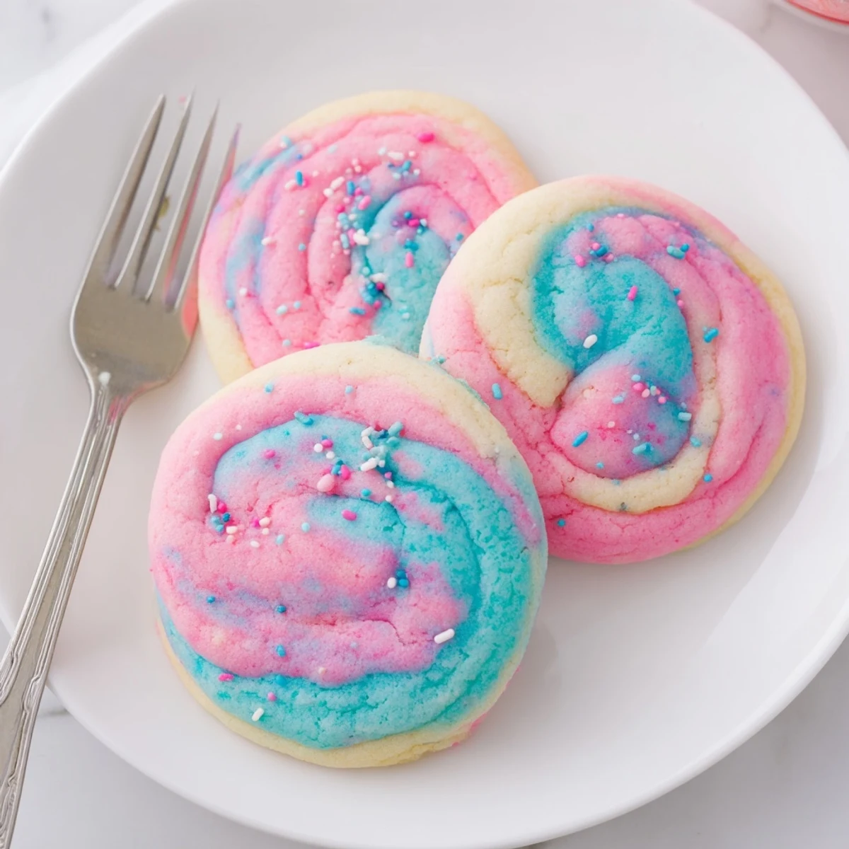 Chewy cotton candy cookies featuring marbled pink and blue hues fresh from the oven