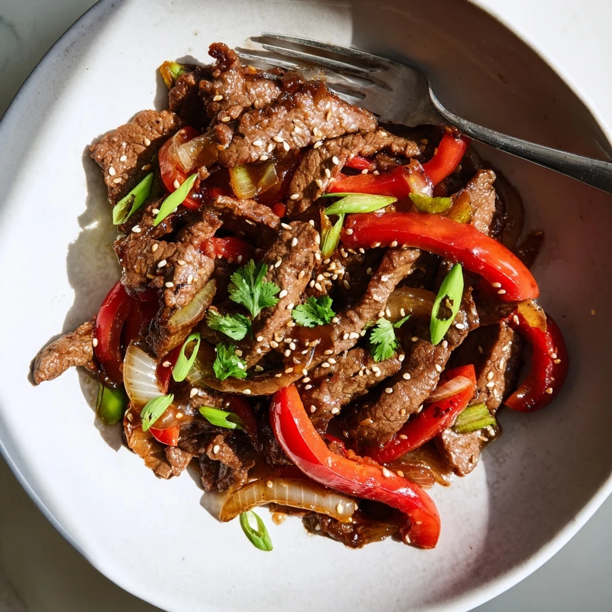 Tender Asian inspired cube steak seared golden and draped in a glossy sesame garlic sauce