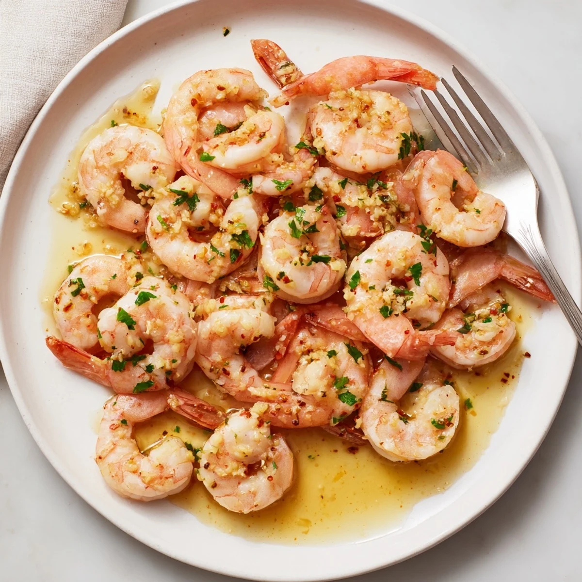 Golden buttered shrimp glistening in a garlicky lemon butter sauce with fresh parsley
