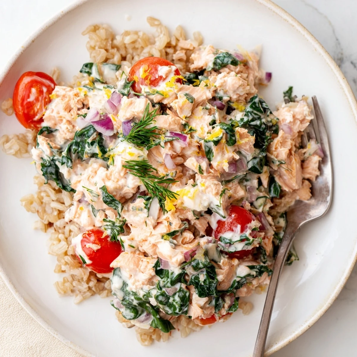 Healthy creamy leftover salmon recipe topped with fresh cherry tomatoes and herbs