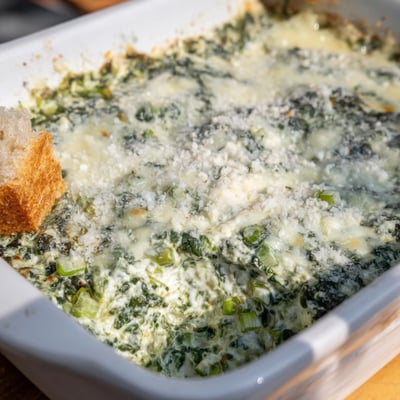 Freshly baked Creamy Spinach Dip with Sourdough Bread, featuring velvety spinach, herbs, and garlic, ready for dipping at a cozy party table.